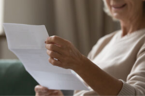 A woman reading some paperwork.