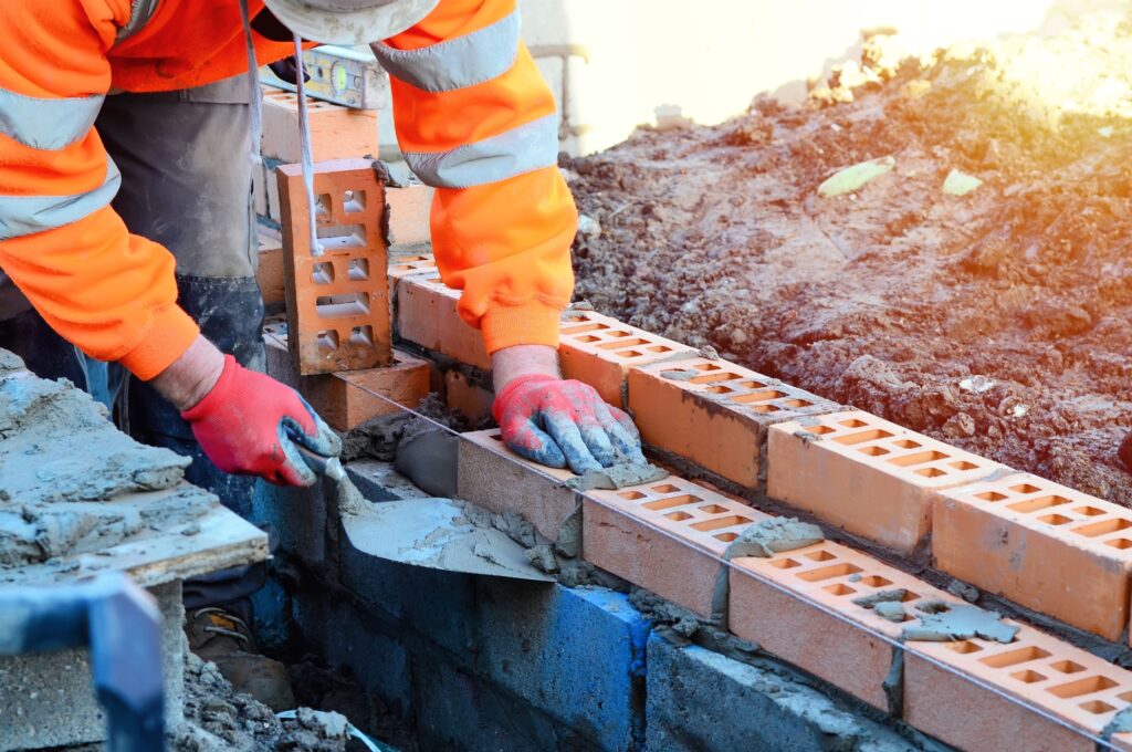 A bricklayer working on a construction site.