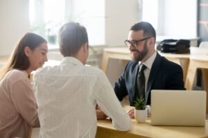 A young couple meeting with a financial planner.