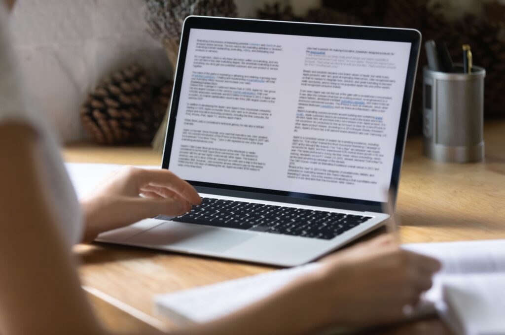 A person reading a document on a computer.